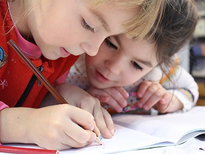 Kids looking at plants with a magnifying glass