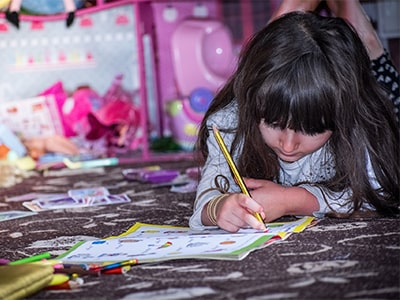 A teacher and child reading a book together